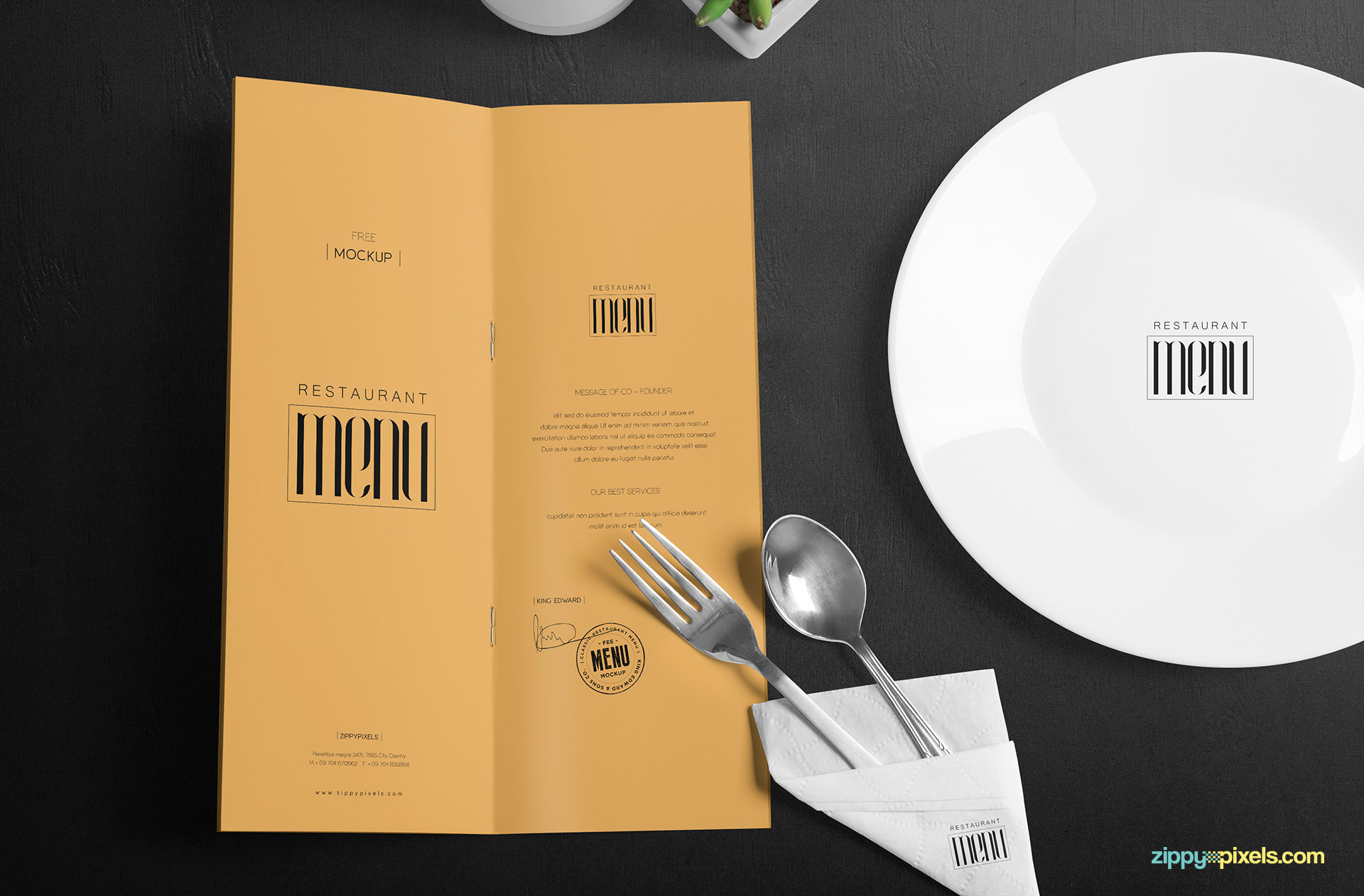 A complete dining table scene with the menu card, plate, cutlery and artificial plant pot.